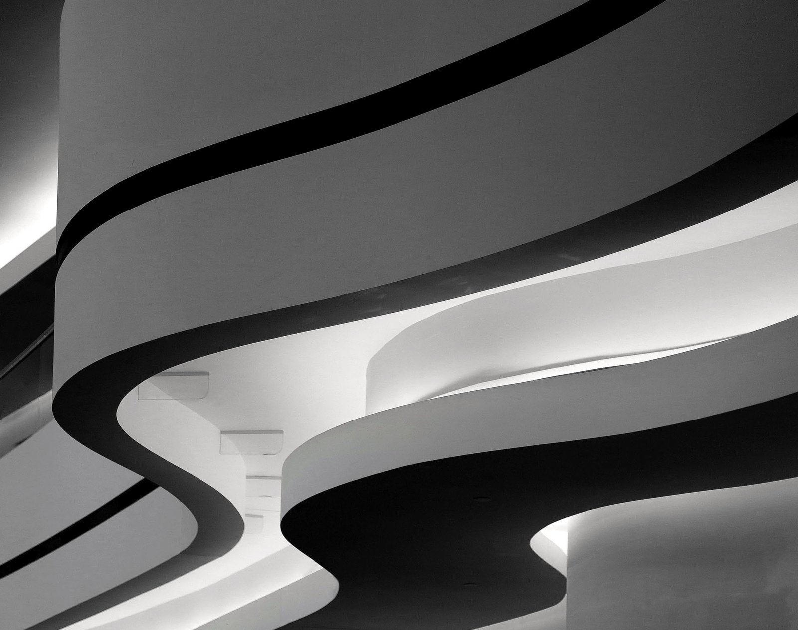 A closeup greyscale shot of a building with curvy twists in Berlin, Germany